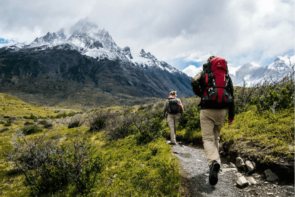 two hikers hiking near mountains