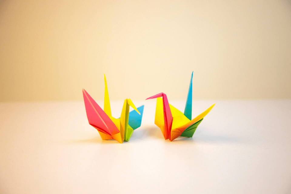 2 multi-coloured origami cranes