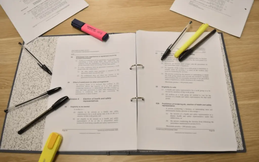 notebook with notes inside and pens around